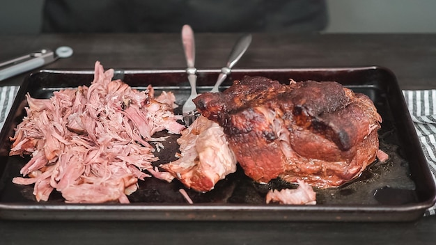 Step by step. Shredding pork roast shoulder with two forks.