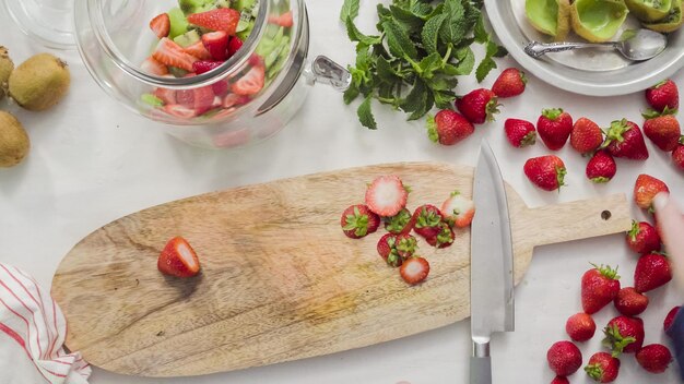 Step by step. Slicing fressh organic fruits for infused water.