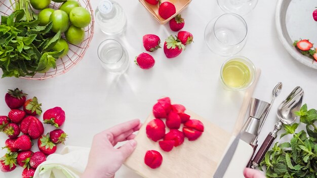 Step by step. Slicing fruit for strawberry mojito from fresh organic strawberries.