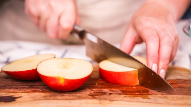 Step by step. Slicing red apples for filling to make empanadas.