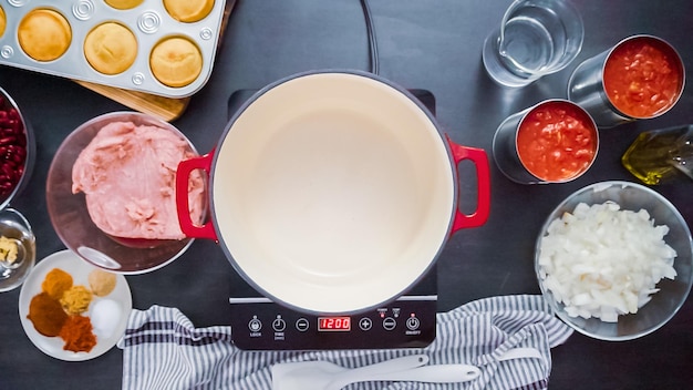 Step by step. Top view. Cooking turkey chili in enameled cast iron covered dutch oven.