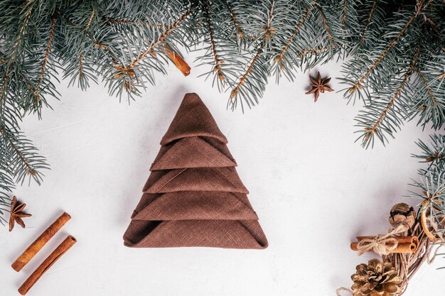 Step-by-step tutorial: Fold linen napkin in shape of Christmas tree. New Year table setting. Step 9: Fold all corners this way. Top view