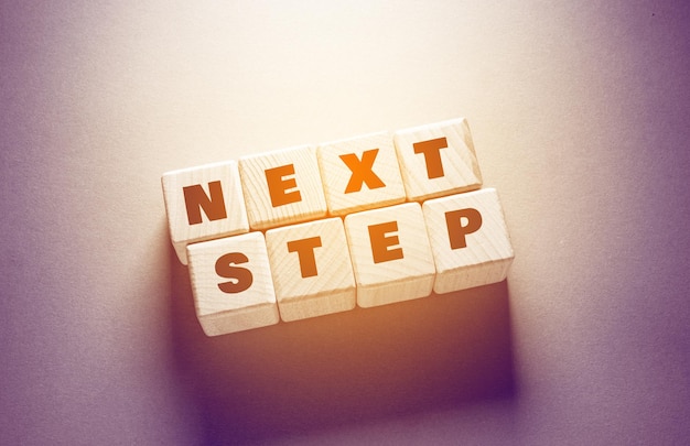 Next Step Word Written on Wooden Cubes