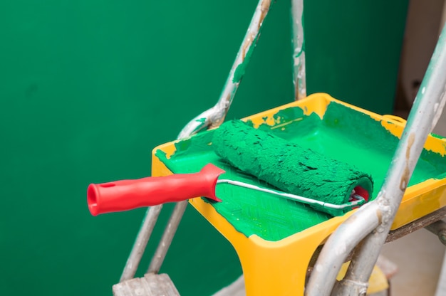 Photo stepladder with tools. a room after renovation. fresh repair in a room