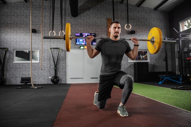 Stepping forward exercise with a barbell on the shoulders