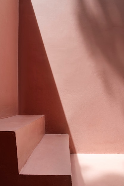 steps by a pink wall with shadows
