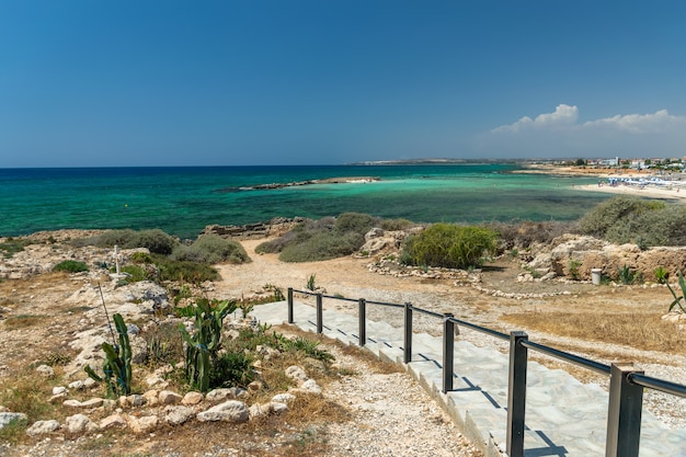 Steps with a railing leading to a picturesque beach.