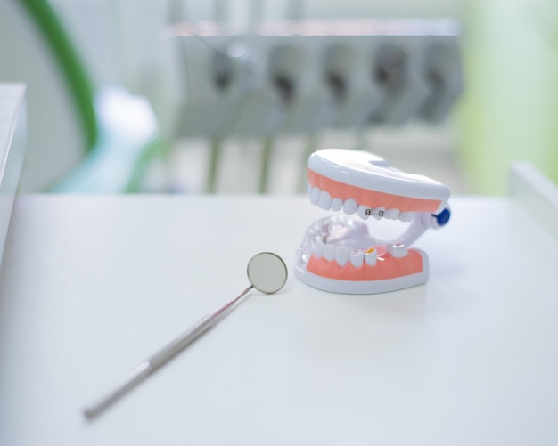 Sterile instruments are in the dentist39s office The mirror and the layout of the jaw lie on the table of the orthodontist Oral hygiene caries prevention examination