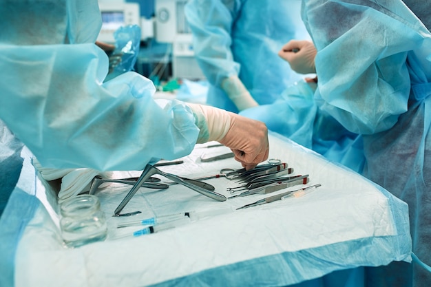 Sterile instruments on the operating table, a team of doctors lays out the instruments for the operation