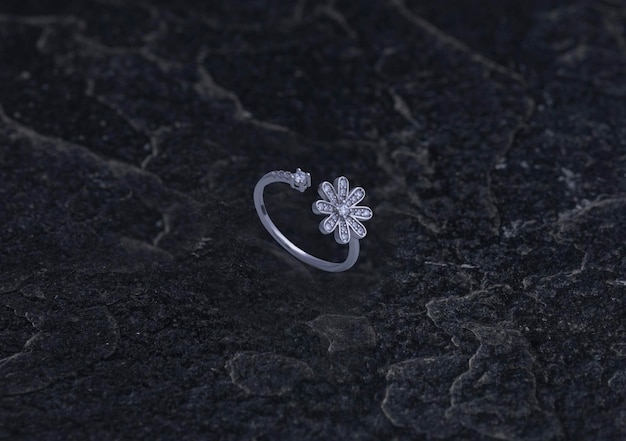 Sterling silver ring on black stone background