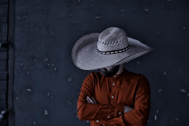 stern cowboy in a hat with brim, straw, retro vintage style, angry man wild west western