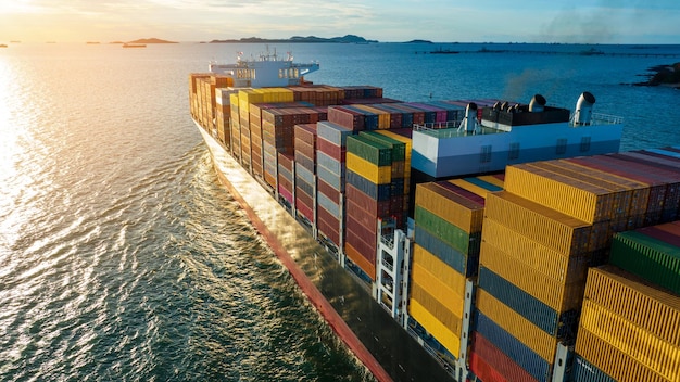 Stern of large cargo ship import export container box on the\
ocean sea on blue sky back ground