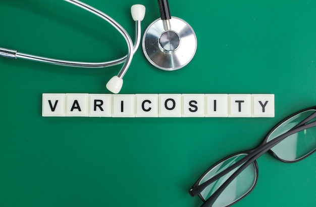 Photo stethoscope and alphabet letters with the word varicosity medical and health concepts