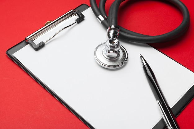 stethoscope and blank clipboard pad 