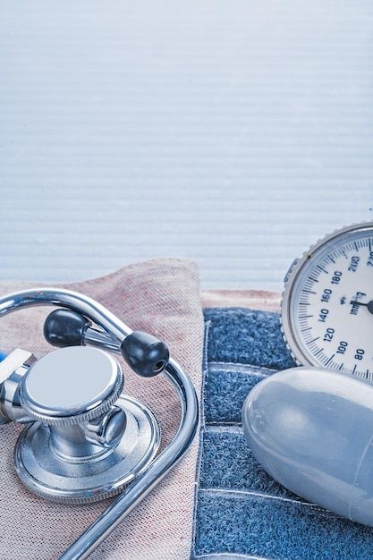 Stethoscope and blood pressure monitor on blue background medical concept