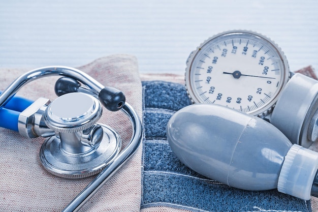 Stethoscope and blood pressure monitor close up on details of its medical concept