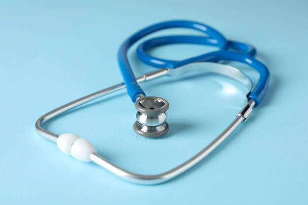 Stethoscope on blue surface, close up. Healthcare