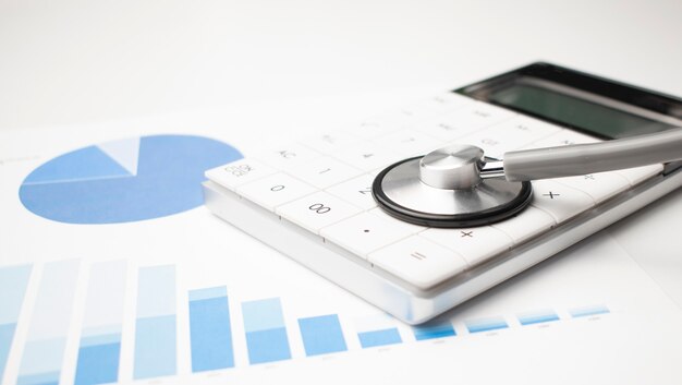 Stethoscope, calculator and documents. Medical and insurance concept