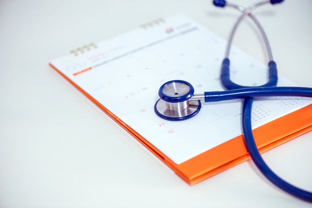 Photo stethoscope and a calendar. doctor's appointment and service in the hospital.