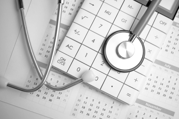 Stethoscope and callculator on the calendar Medical concept