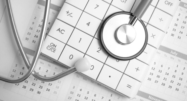 Stethoscope and callculator on the calendar Medical concept