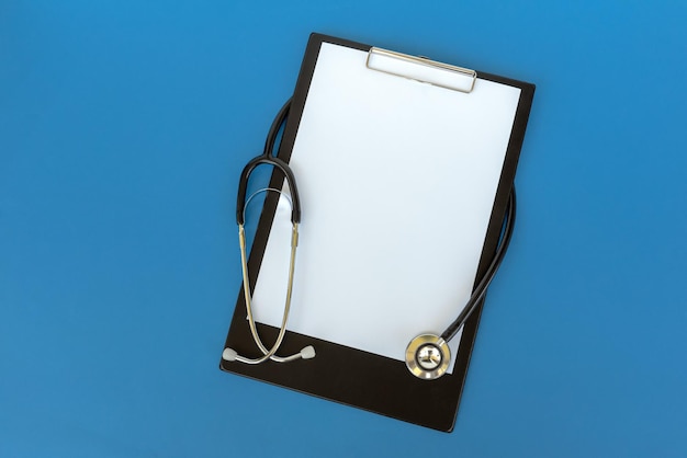 Photo stethoscope and clipboard on blue background health and medical concept