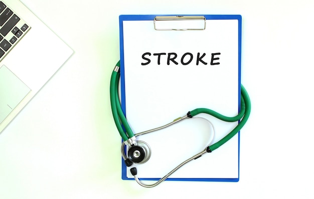 Stethoscope and clipboard with STROKE text on white sheet of paper and copy space