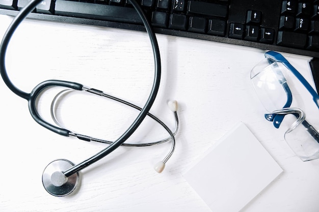 stethoscope and drugs on a computer keyboard medical pharmaceutical concept