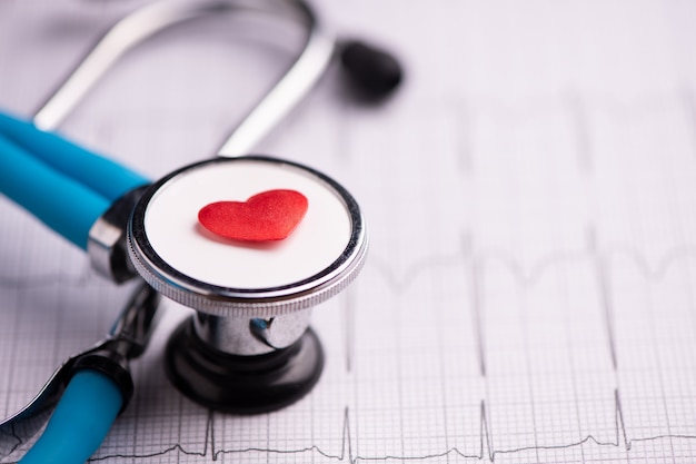a stethoscope on ecg medical report close up