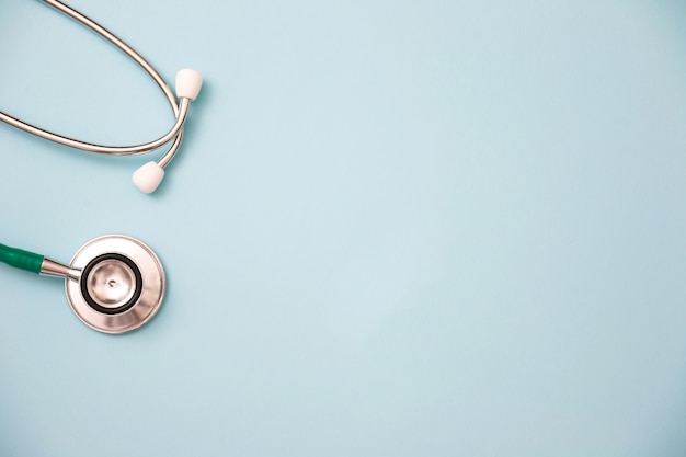 Stethoscope on green background