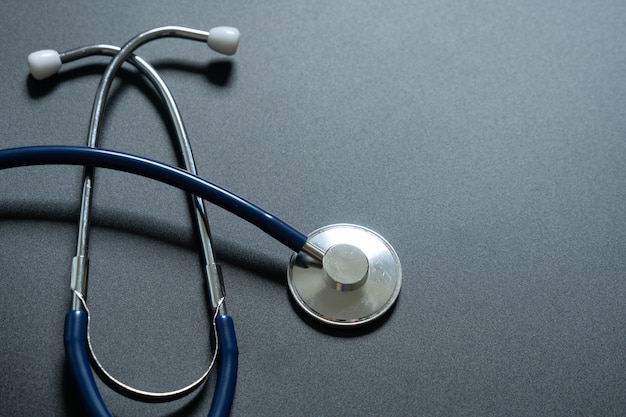 Photo stethoscope on grey background, top view