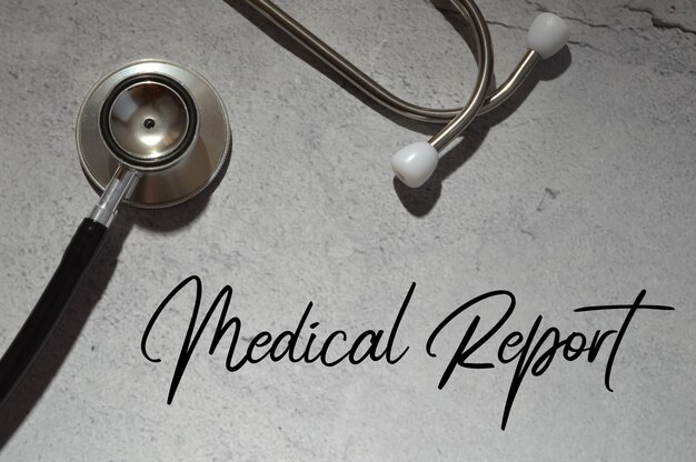 Stethoscope over grey background written with text MEDICAL REPORT