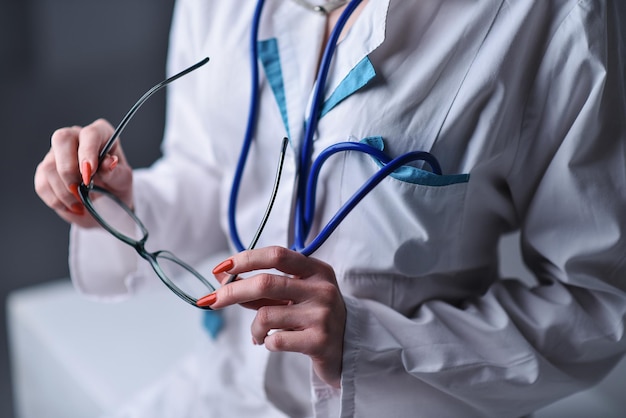 A stethoscope in the hands of the doctor