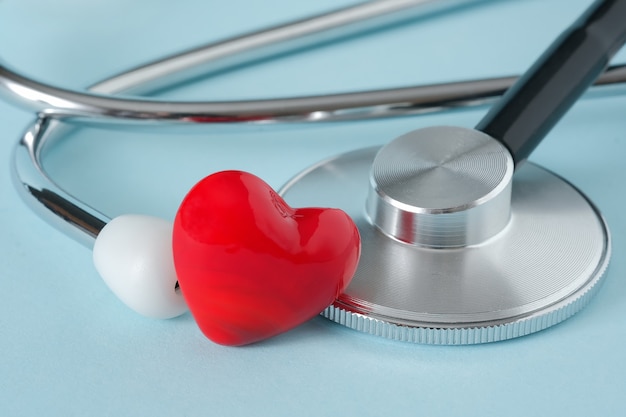 Stethoscope and heart on blue background