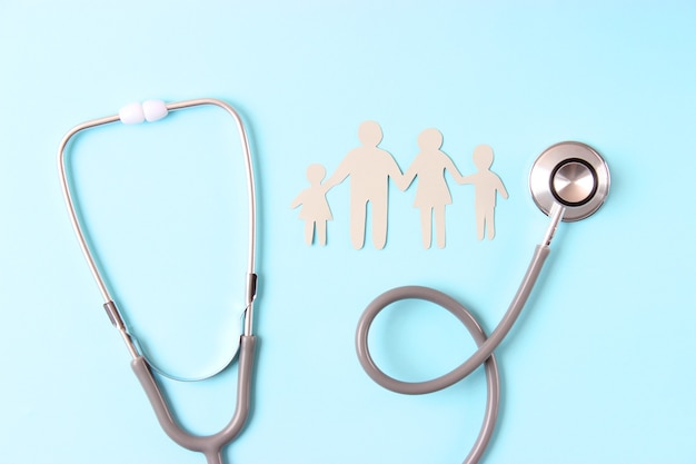 Stethoscope and heart on a colored background top view family medicine