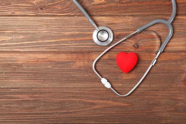 Stethoscope and heart on wooden background health medicine