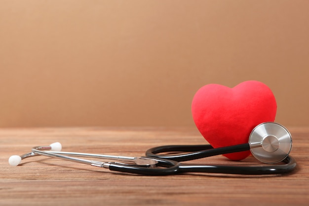 Stethoscope and heart on wooden background health medicine