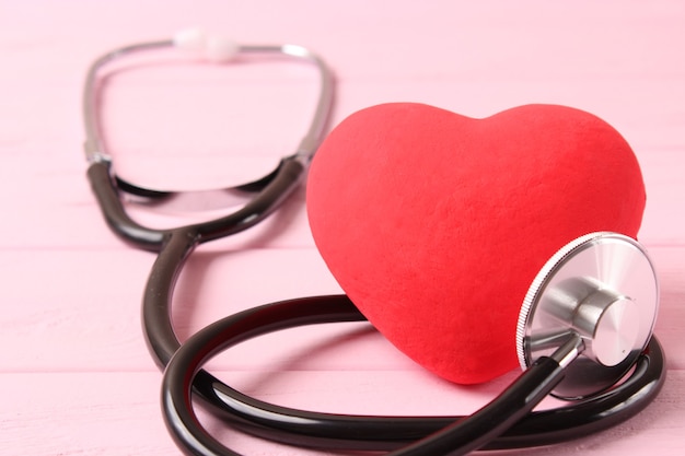 Stethoscope and heart on wooden color background health medicine