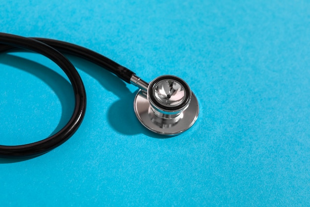 Stethoscope isolated on blue . Copy space for text