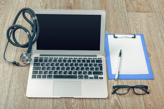 Stethoscope on laptop, close-up