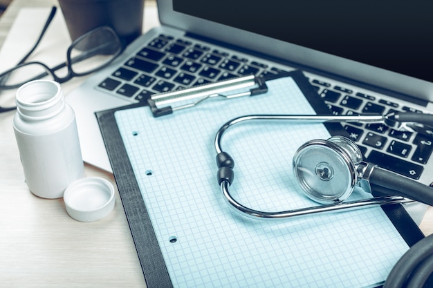 Stethoscope on laptop, close-up