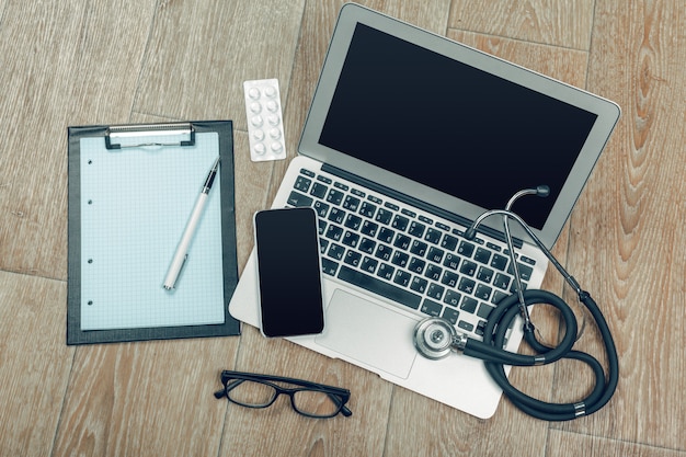 Stethoscope on laptop, close-up