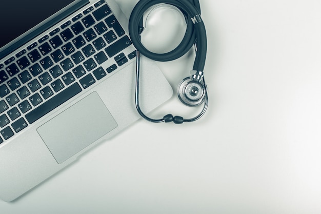 Stethoscope on laptop, close-up