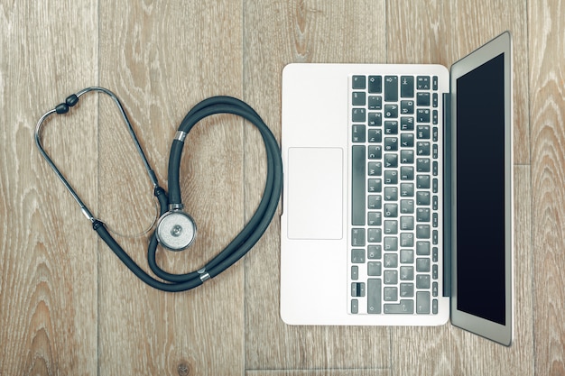 Stethoscope on laptop, close-up