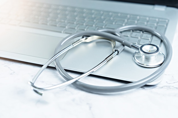 Stethoscope on laptop on table.  Object for doctor and technology