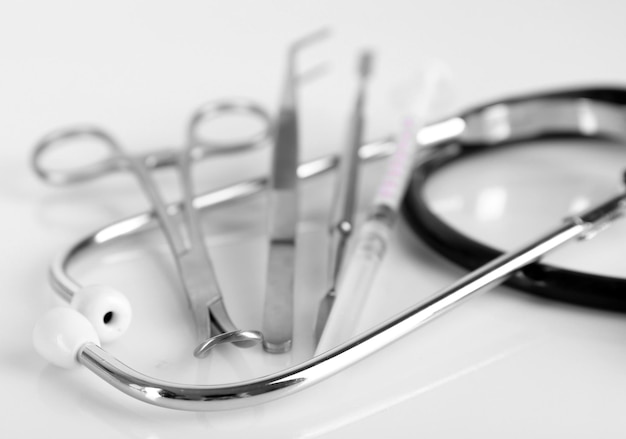 Photo stethoscope and medical instruments on white background close up