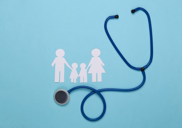 Stethoscope and paper chain family on blue, health insurance concept