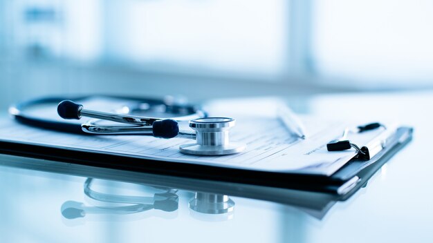 Stethoscope and pen laying on patient information blank.