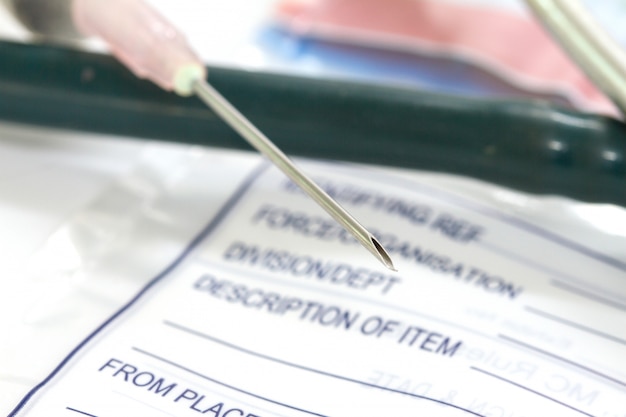 Photo stethoscope, pills and syringe on diagnosis background