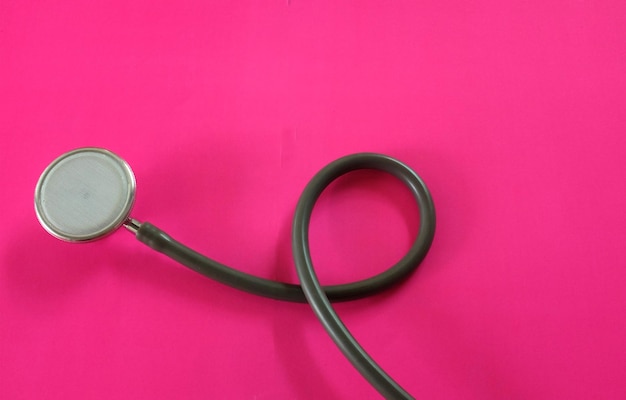 Photo stethoscope on pink doctor tabledoctor equipment concept